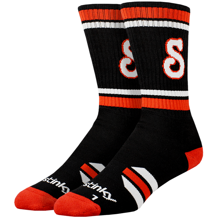 Black socks with red and white accents and 'Stink' branding on a white background