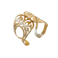 A gold-colored cuff bracelet with geometric openwork design, inspired by ancient Bactrian gold ornaments.
