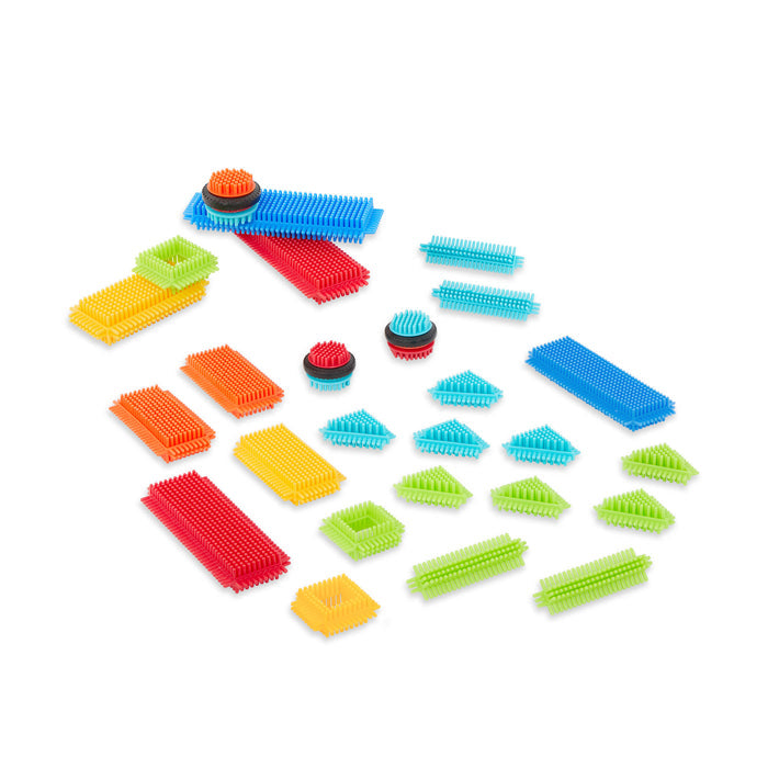 Creations made with Bristle Blocks, including a car with functional wheels.