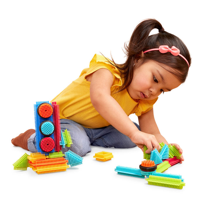 Creations made with Bristle Blocks, including a car with functional wheels.