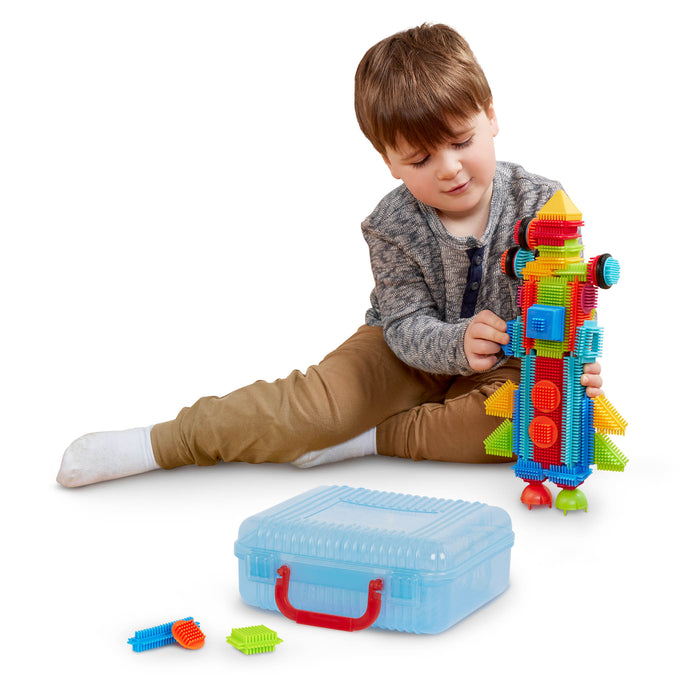 Bristle Blocks laid out in a rainbow pattern.