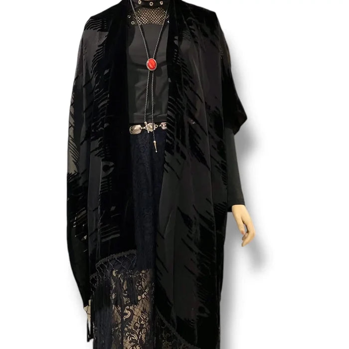 Black long fringe velvet duster jacket with wavy burnout texture, open-front kimono style, relaxed sleeves, and tassel hem for boho western festival layering regular-plus size