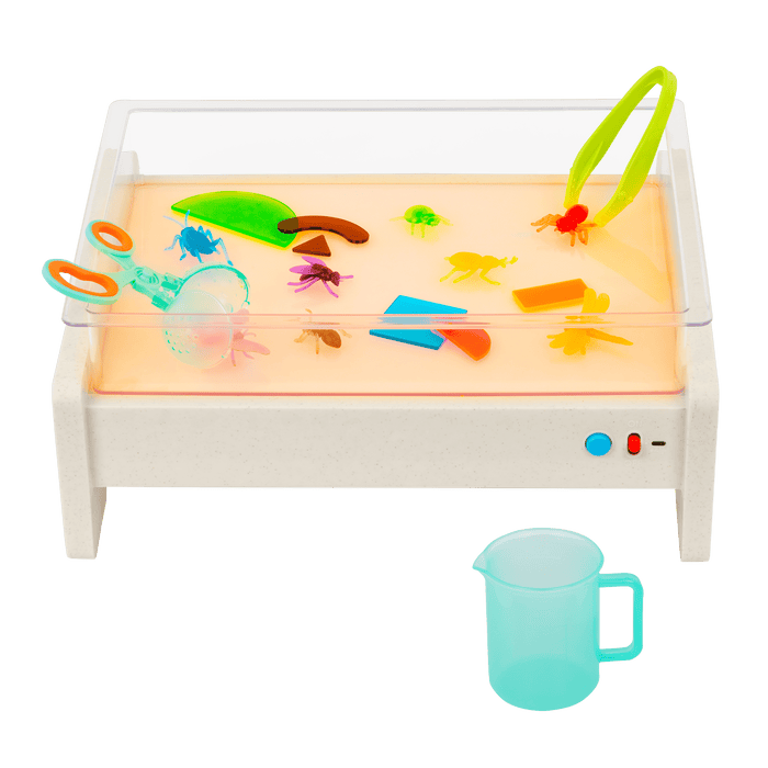 Light box playset with transculent shapes and bugs, tools, and a booklet.