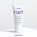 Color Wow Curl Wow Coco-Motion Conditioner Travel Size 60ml tube on a white background, nourishing conditioner that restores moisture, improves elasticity, detangles curls, and enhances softness, bounce, and definition.