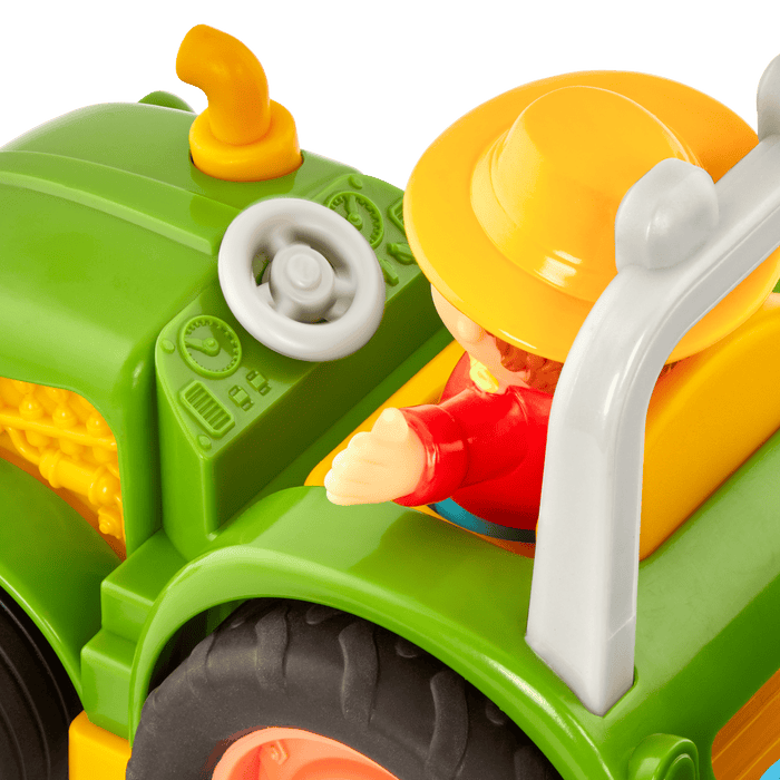 Toy tractor with a farmer and animal figurines.