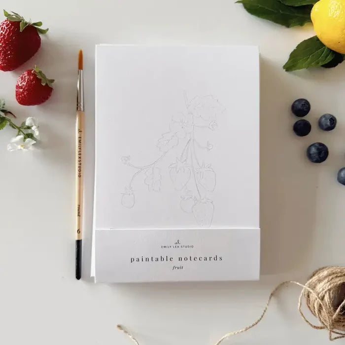 White notecard with 'paintable notecards' branding, surrounded by strawberries, lemons, and blueberries on a light surface.
