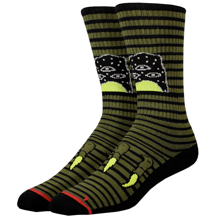 Pair of green striped socks with a black and white design on a white background