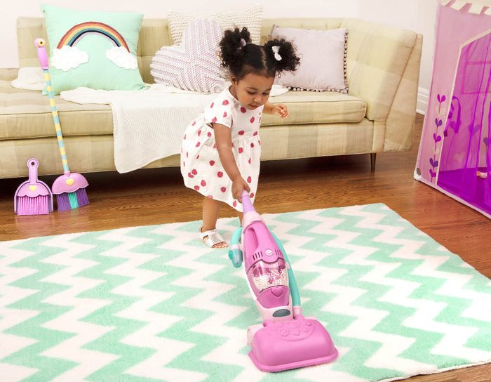 A pink toy vacuum for toddlers and kids.