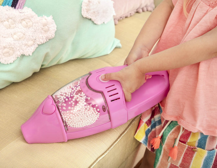A pink toy vacuum for toddlers and kids.