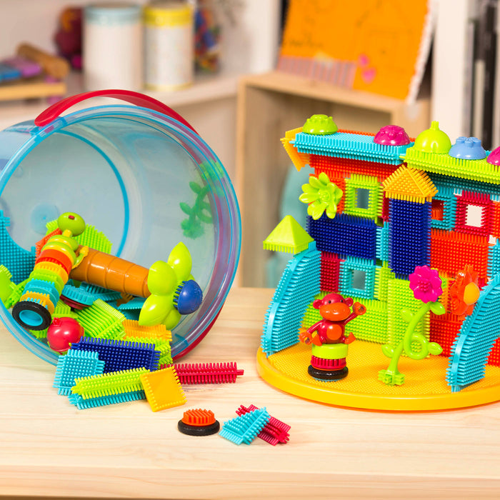 A vehicle and structure made with Bristle Blocks.