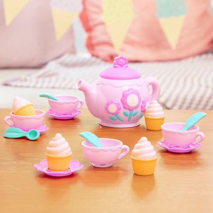 A toy tea set with toy cupcakes.
