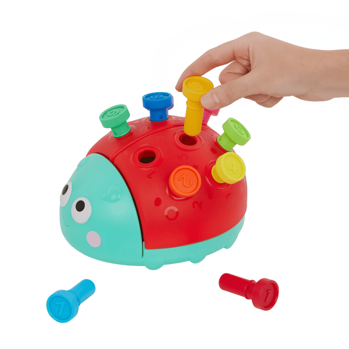 Colorful ladybug peg toy with booklet.