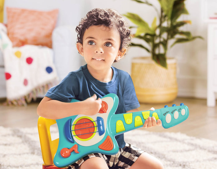 Toy guitar, with a blue body and green and orange buttons.
