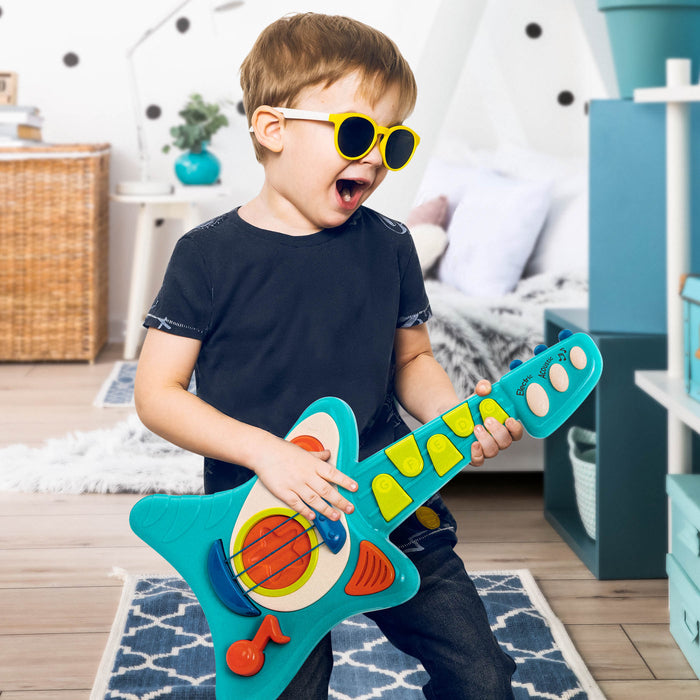 Toy guitar, with a blue body and green and orange buttons.