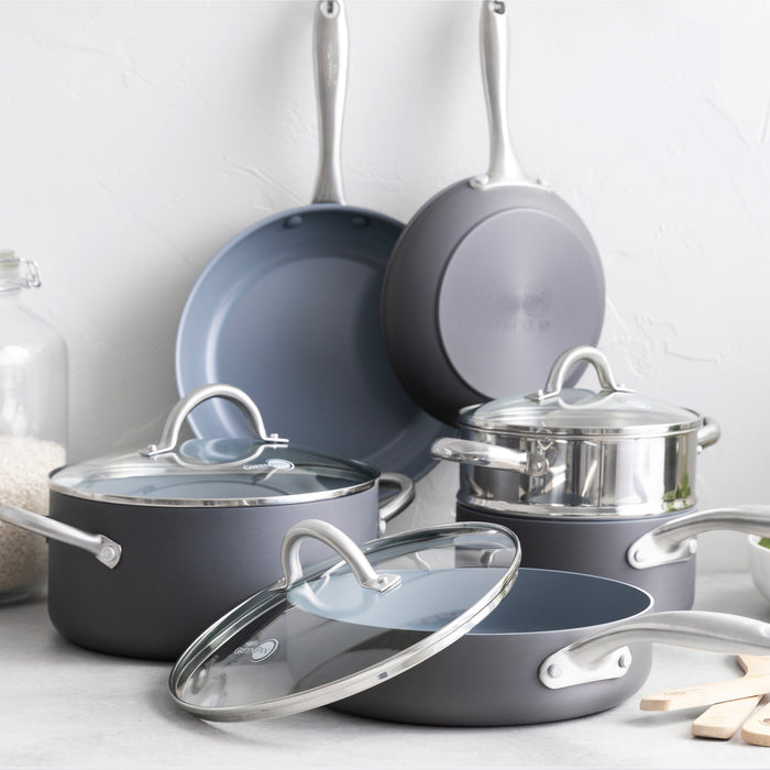 12-piece ceramic nonstick cookware set with glass lids and silver handles displayed on a kitchen counter.