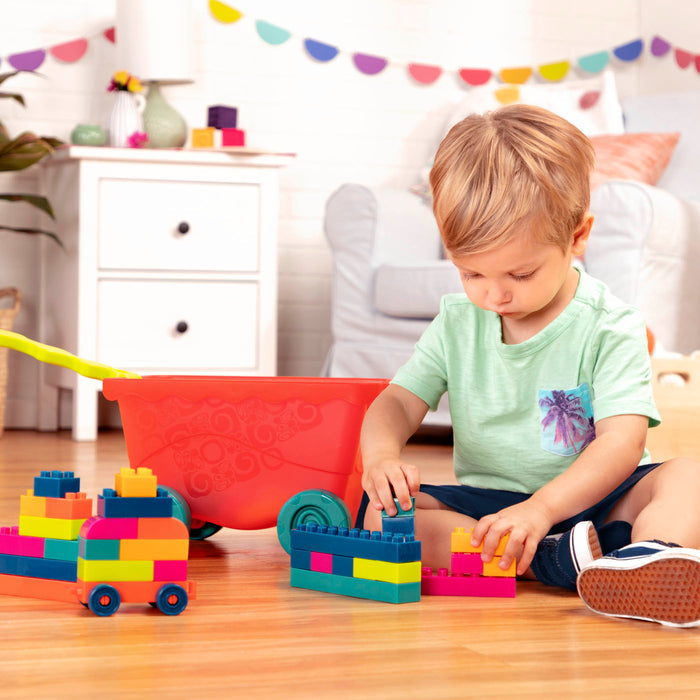 Colorful building blocks and a wagon.