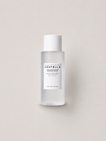 A bottle of Korean skincare toner -  SKIN1004 Madagascar Centella Tone brightening Boosting Toner, featuring a frosted glass bottle and a white cap, set against a solid light beige background. 210 ml.