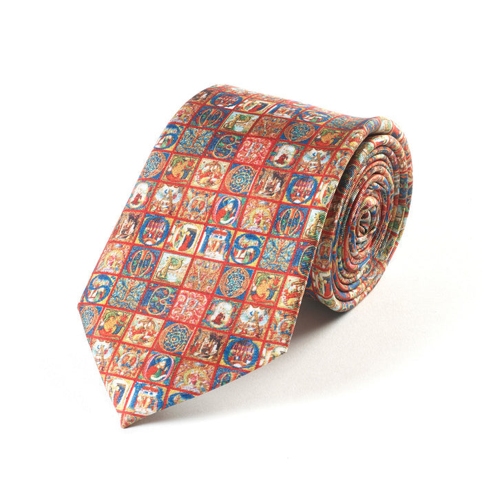A silk tie with a medieval alphabet pattern in a variety of colors.