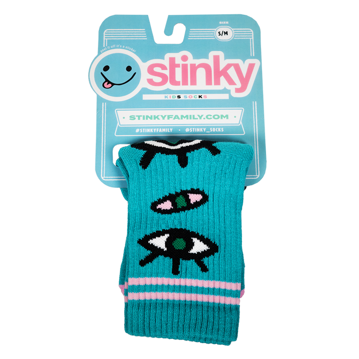 Teal dog toy with eye designs in packaging featuring the brand 'Stinky'.