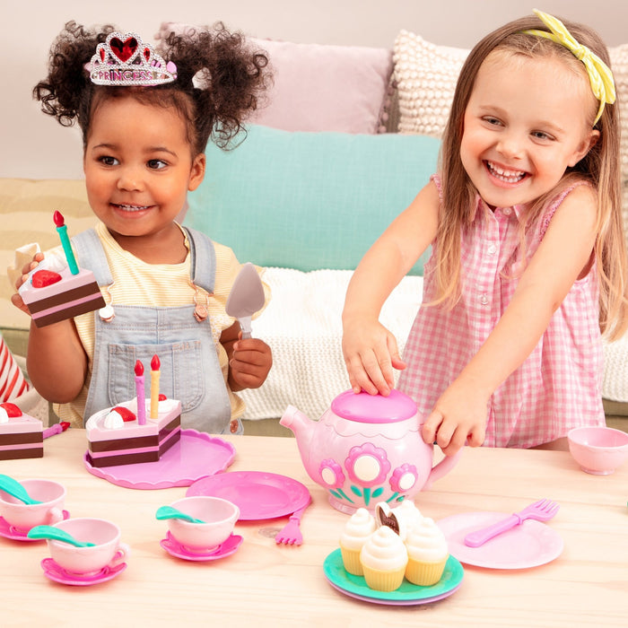 2 slices of pretend birthday cake with candles and utensils.