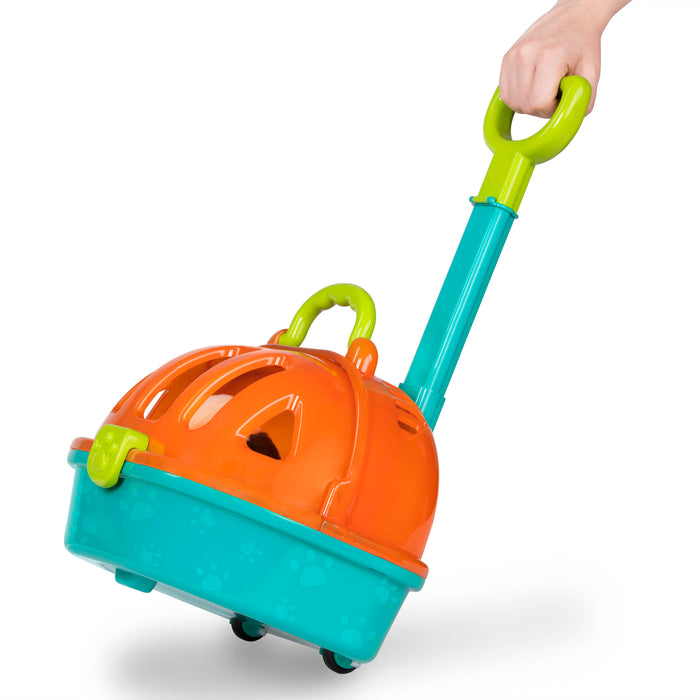 A toy pet carrier with a plush puppy inside and vet tools surrounding it.