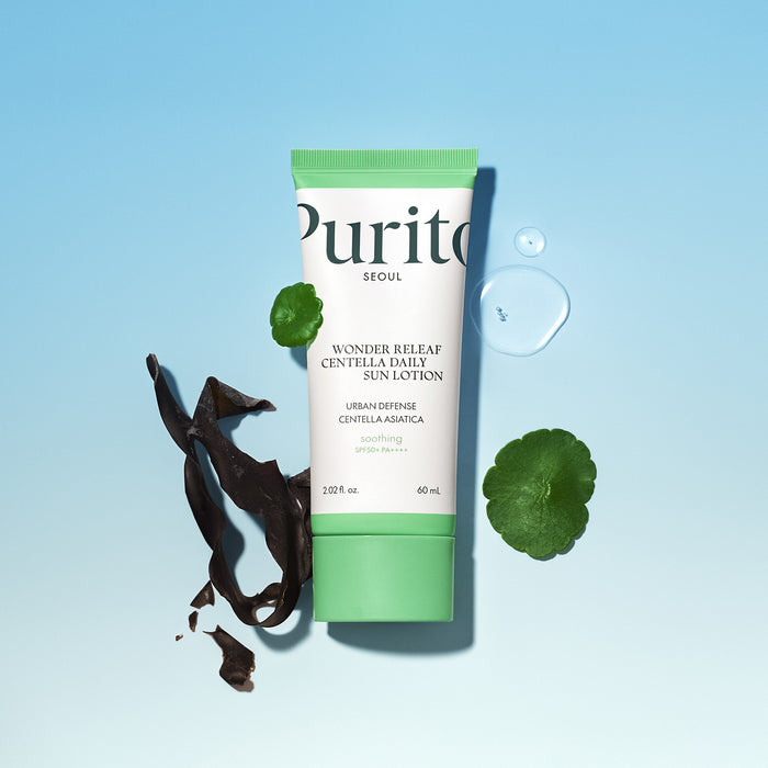 Tube of Purito Wonder Releaf Centella Asiatica Sun Lotion on a light blue background with green leaves and a drop of water.