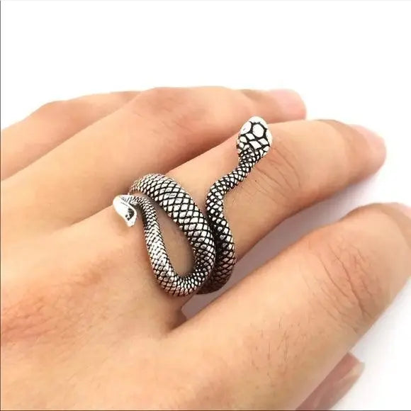 woman wearing middle finger Silver Heads Up Snake Wrap Ring with raised snake head and textured open band