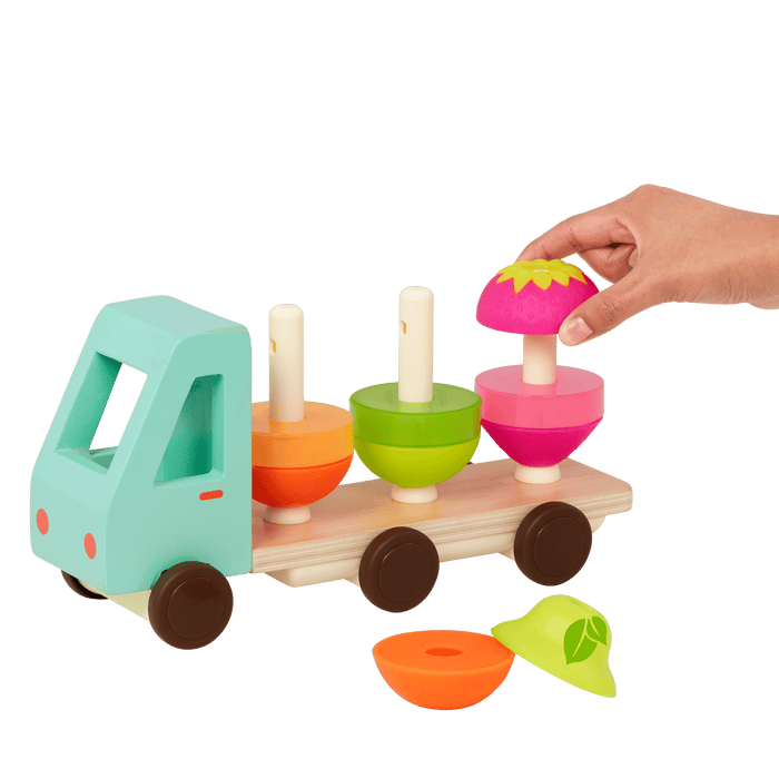 Toy truck with stackable fruits.