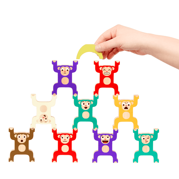 Colorful stacked monkey and fruit toys with a booklet.