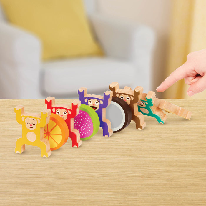 Colorful stacked monkey and fruit toys with a booklet.