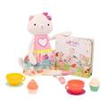 Tea set with plush cat and book.