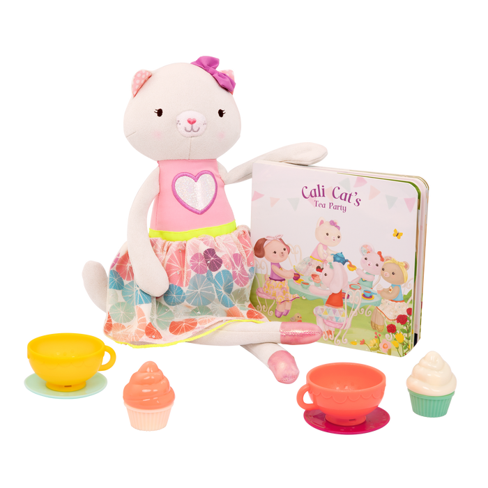 Tea set with plush cat and book.