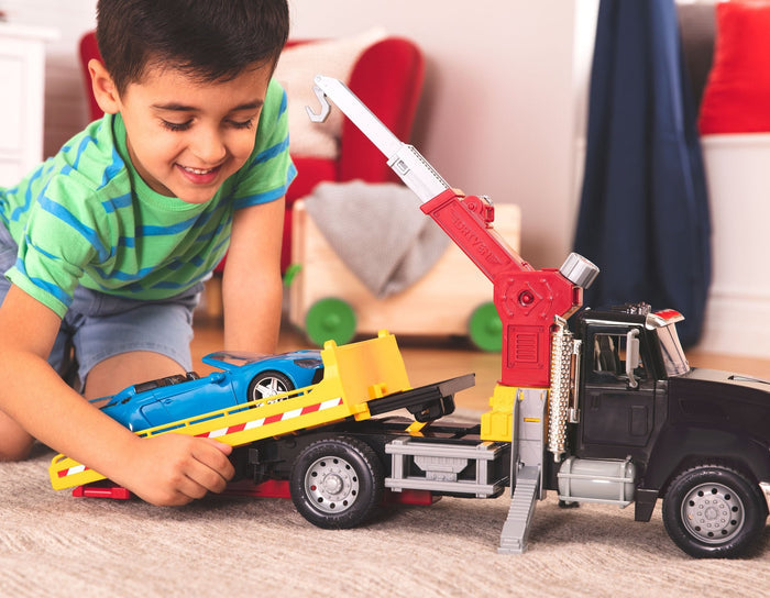 Black toy tow truck towing blue car