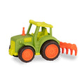 A green and orange tractor toy with a rake in the back.