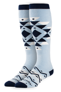 Pair of light blue knee-high socks with geometric pattern on a white background