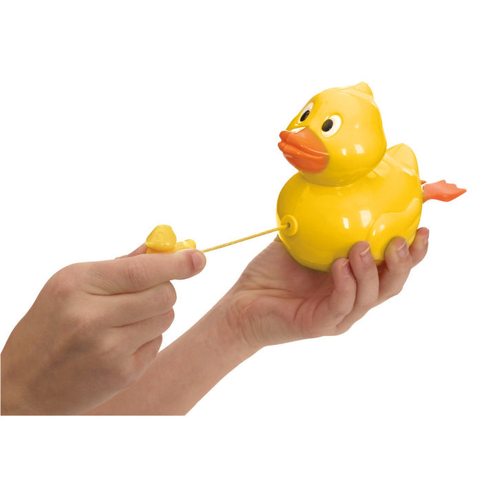 A person holds the Tub Time Pull-String Duck bath toy, featuring an orange beak, tail, and large cartoon eyes, and pulls the attached yellow string to activate this interactive Tub Time toy.