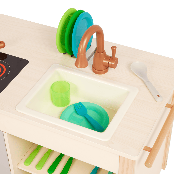 Wooden toy kitchen with colorful accessories.