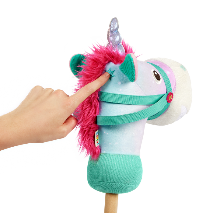 green and pink unicorn hobby horse with wooden riding pole