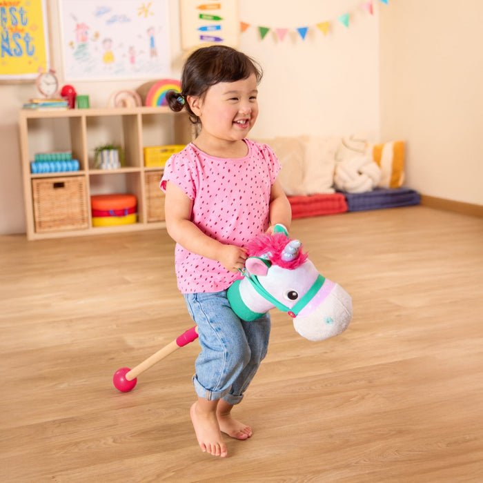 green and pink unicorn hobby horse with wooden riding pole