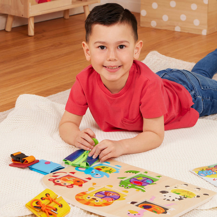 Booklet and basic skills board with animal illustrations and fasteners.