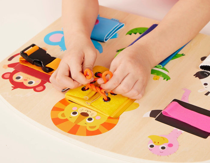 Booklet and basic skills board with animal illustrations and fasteners.