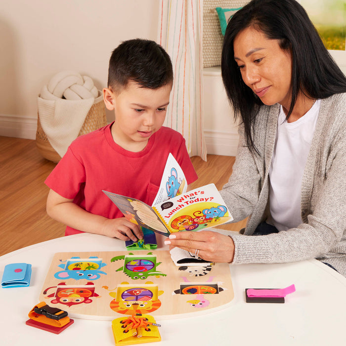 Booklet and basic skills board with animal illustrations and fasteners.