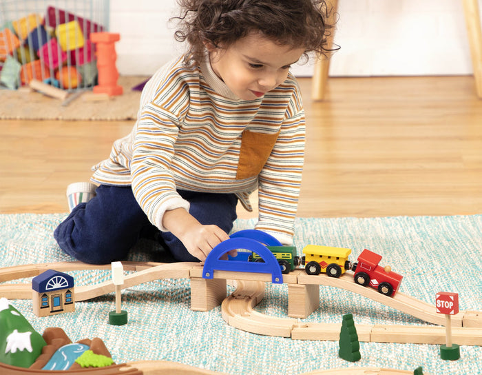 Storage that doubles as a mountain landscape with tracks over a pretend river.
